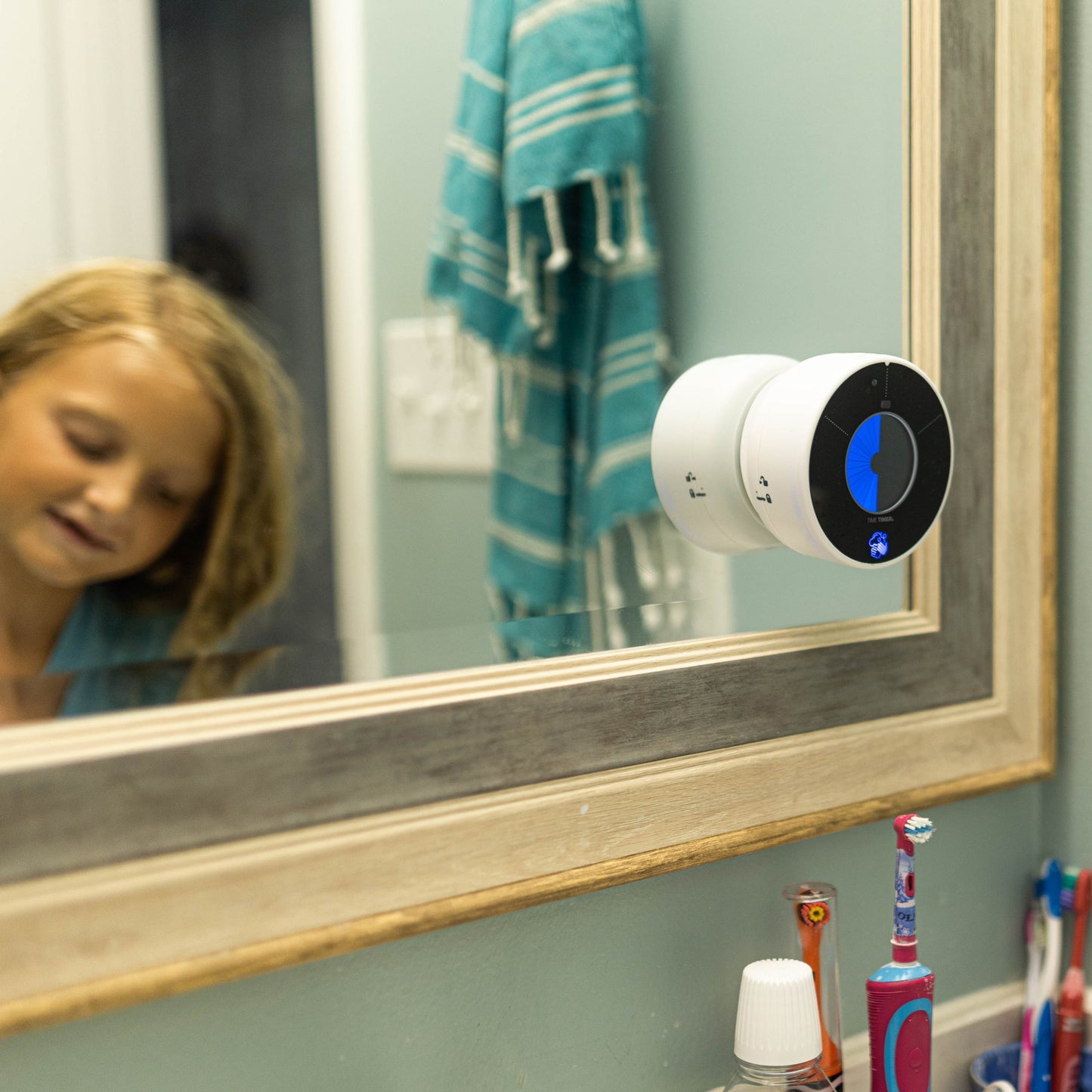 A child using the Time Timer WASH at home to wash her hands properly